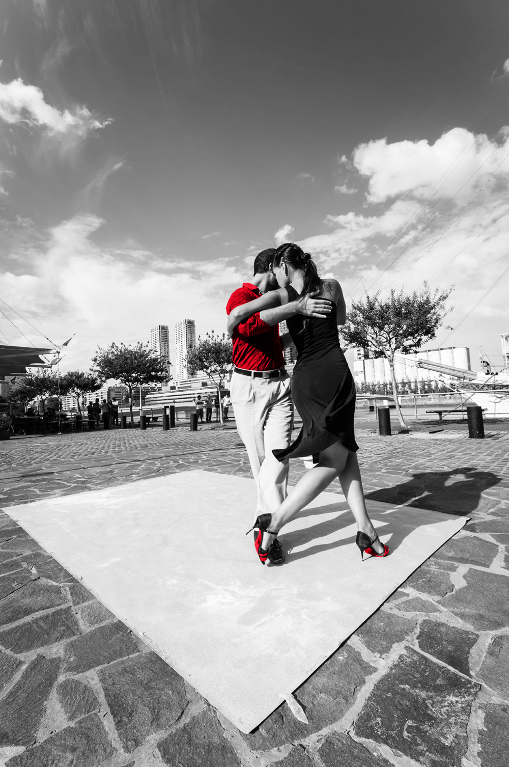 Buenos Aires, Argentina - February 08 2012: A couple dancing tango in the streets of Puerto Madero and waiting for someone to leave a tip.
